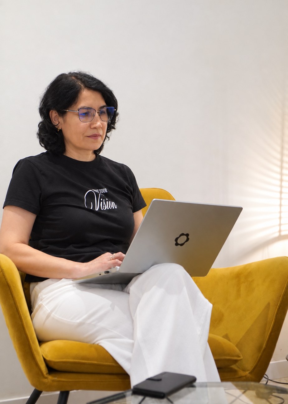 Angela Kadirov working on a laptop